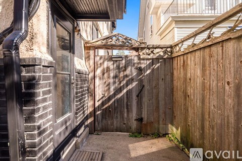 A wooden fence and gate in front of a building.