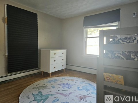 A child's bedroom with a white dresser and a bunk bed.