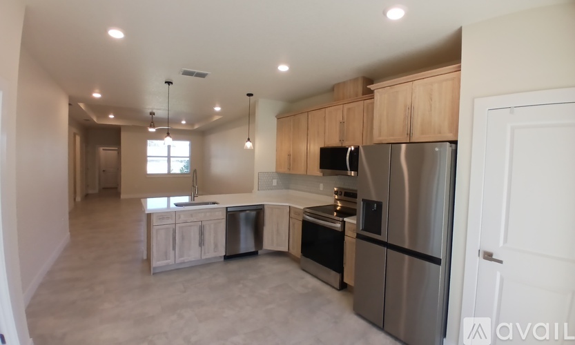 A kitchen with stainless steel appliances and wooden cabinets.