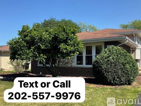 A house with a tree in front and a sign that says "Text or Call 202-557-9976".