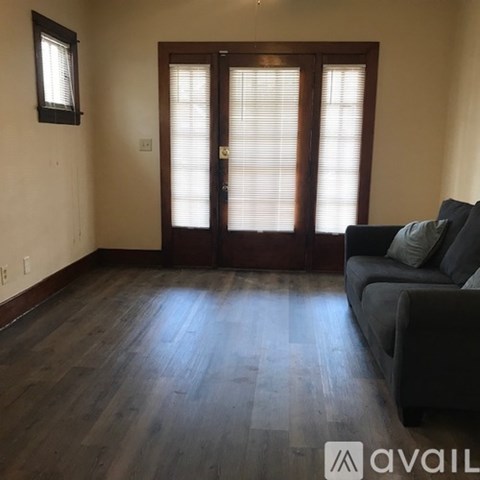A living room with a couch and a sliding door.