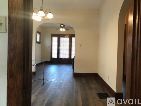 A room with a wooden floor and a ceiling fan.