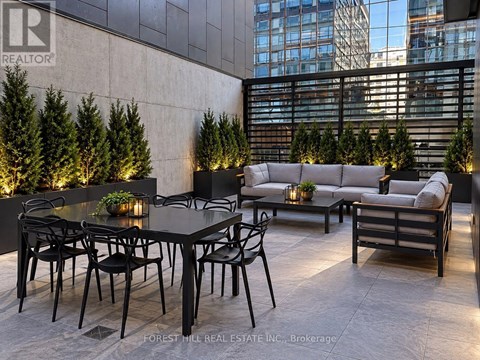 A black table with chairs is set up on a patio.