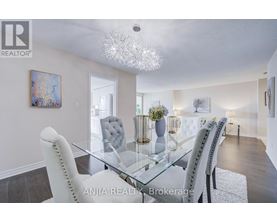 A dining room with a glass table and chairs.