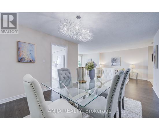 A dining room with a glass table and chairs.