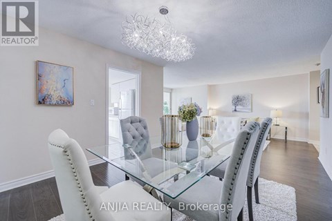 A dining room with a glass table and chairs.