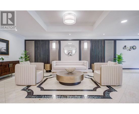 A well-lit, modern living room with a large coffee table and comfortable seating.