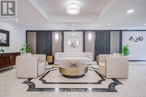 A well-lit, modern living room with a large coffee table and comfortable seating.
