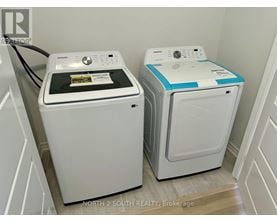 Two front loading washing machines in a laundry room.