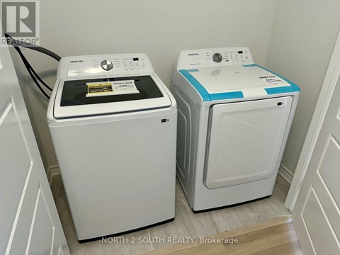 Two front loading washing machines in a laundry room.