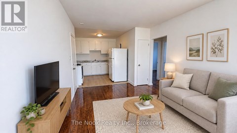A living room with a couch, a coffee table, and a television.