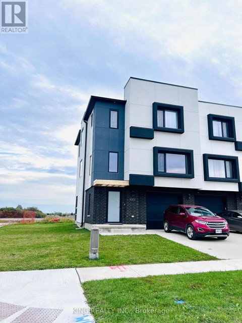 A modern two-story building with a red car parked in front.