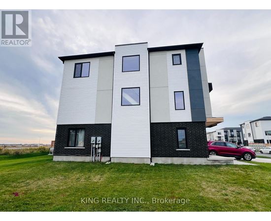 A modern two-story house with a white and black exterior is for sale.