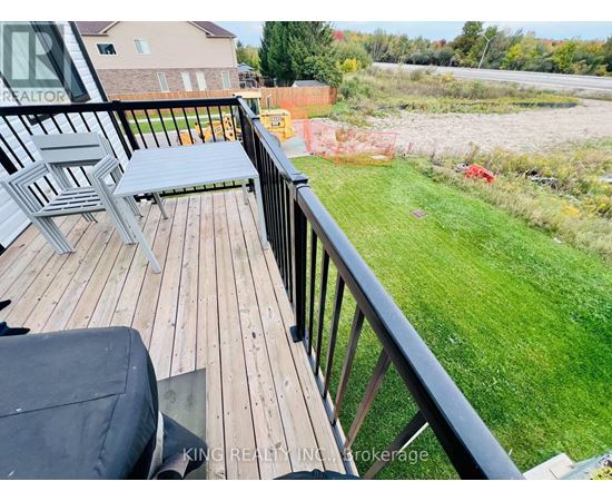 A wooden deck with a bench and a table.