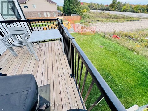 A wooden deck with a bench and a table.
