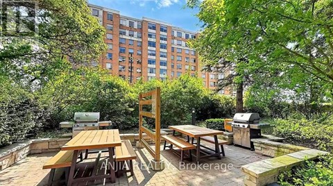 A backyard with a grill and picnic table.