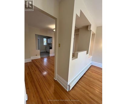 A room with wooden floors and white walls.