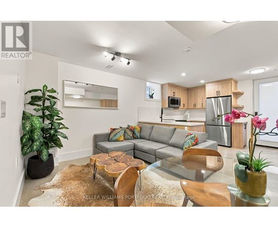 A living room with a grey couch and a wooden coffee table.