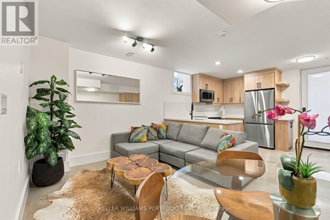 A living room with a grey couch and a wooden coffee table.