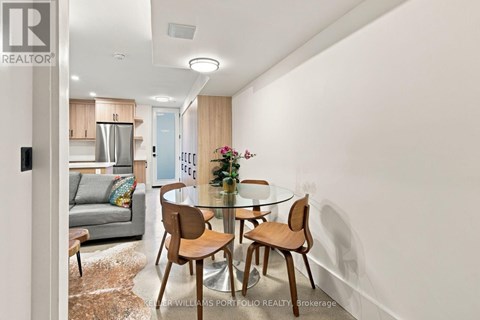 A dining room with a glass table and chairs.