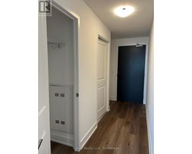 A hallway with a white door and a black door.