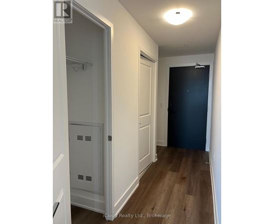 A hallway with a white door and a black door.