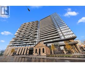 A tall building with many windows is the focal point of the image.