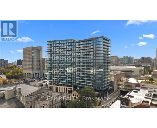 A tall building with many windows is the focal point of the image.