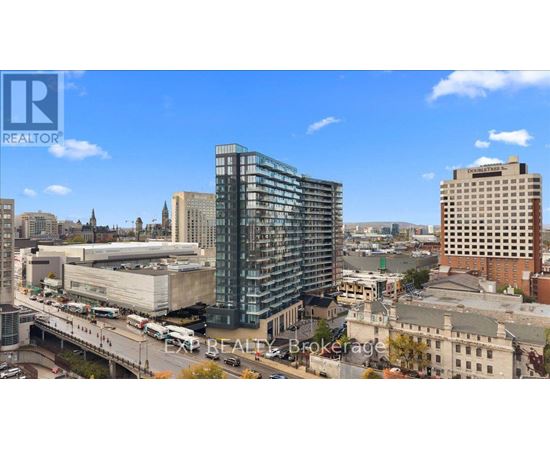 A cityscape with a modern glass building in the center.