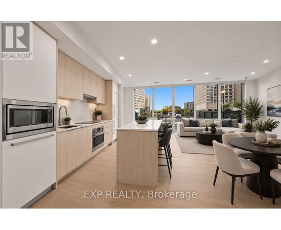 A modern kitchen with a dining area in a real estate brokerage.