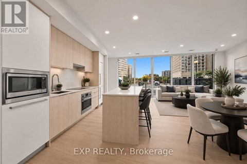A modern kitchen with a dining area in a real estate brokerage.
