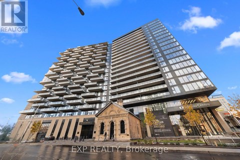A tall building with many windows is the focal point of the image.