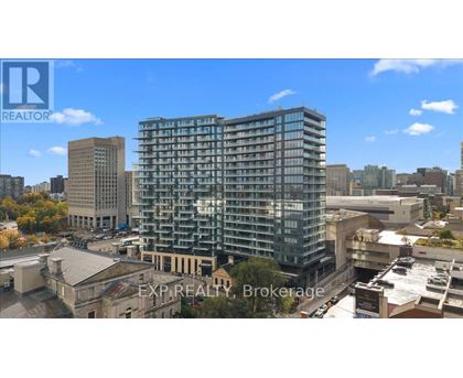 A tall building with many windows is the focal point of the image.