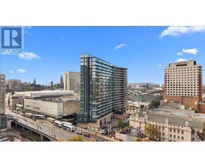 A cityscape with a modern glass building in the center.