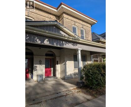 A building with a red door and a sign that says "REALTOR".