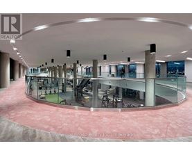 A large atrium with a glass wall and a circular floor.