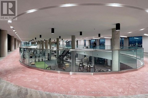 A large atrium with a glass wall and a circular floor.