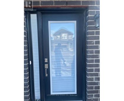 A black door with a glass window and a key in the lock.
