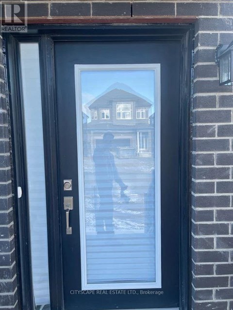 A black door with a glass window and a key in the lock.