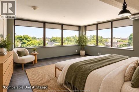 A bedroom with a large bed and a view of the outdoors.