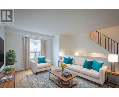 A living room with a couch, chair, and coffee table.