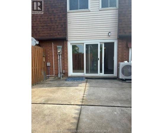 A house with a Realty sign on the wall.