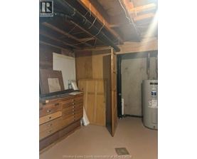 A room with a filing cabinet and a filing system.