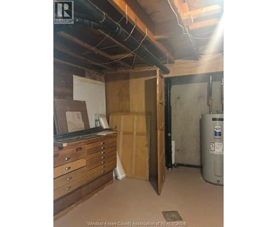 A room with a filing cabinet and a filing system.
