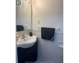 A bathroom with a sink and a mirror.
