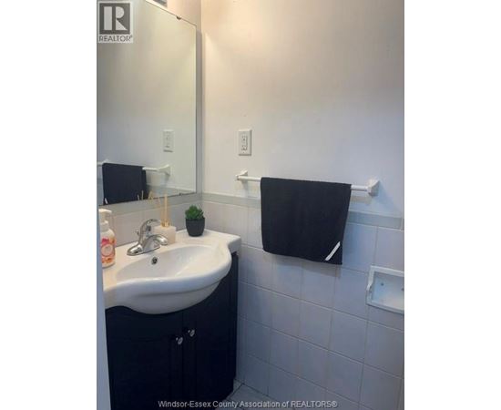 A bathroom with a sink and a mirror.