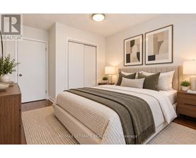 A bedroom with a large bed and two framed pictures on the wall.