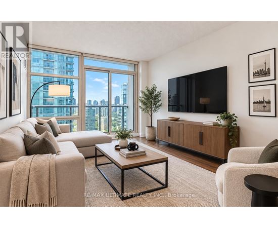 A living room with a large window, a couch, a coffee table, and a flat-screen TV.