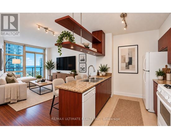 A modern kitchen with a wooden island and white appliances.