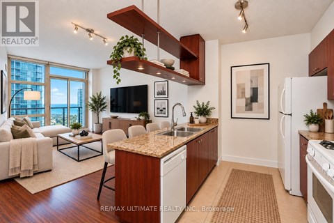 A modern kitchen with a wooden island and white appliances.